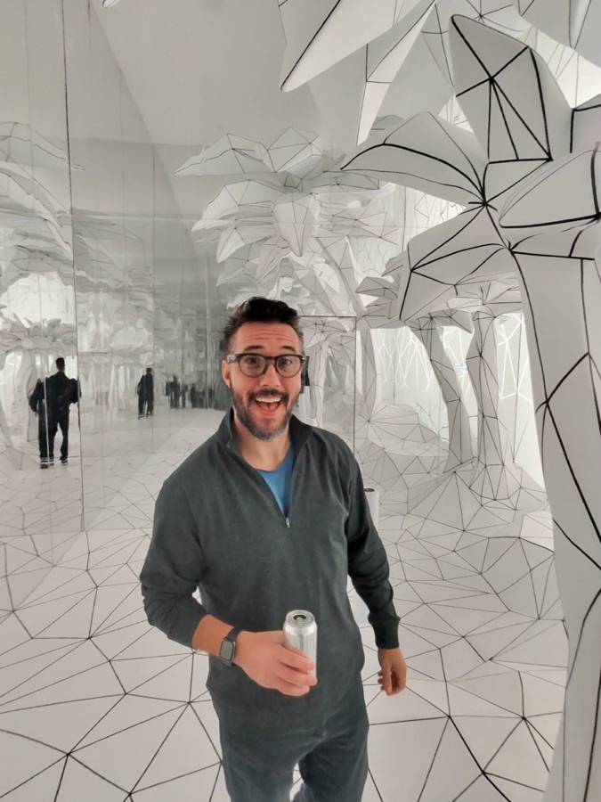 Max wearing Meta Glasses, holding a drink