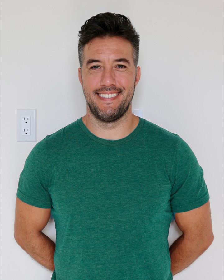 Max smiling, clean green t-shirt headshot