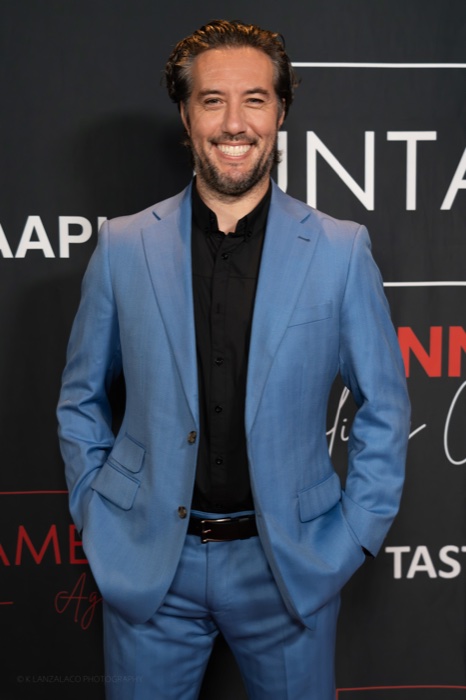 Max in a light blue suit on the red carpet at the Untamed Gala