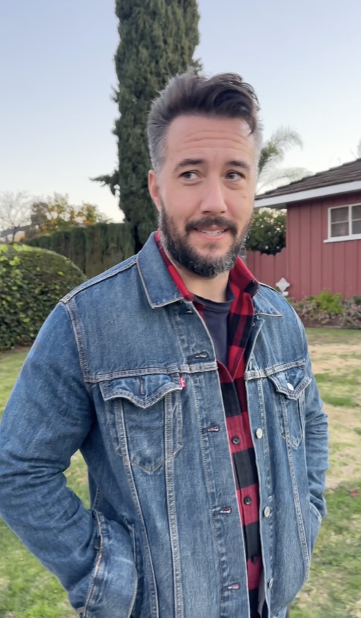 Max in denim jacket and flannel, lifestyle backyard